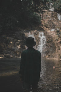 Rear view of man standing in forest