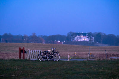 Bicycle on field against sky