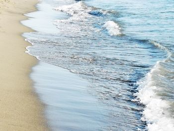 High angle view of waves rushing towards shore