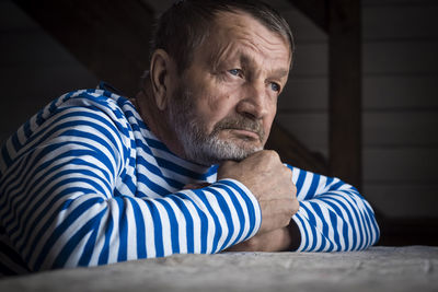 Portrait of man sitting at home