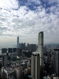 View of skyscrapers against cloudy sky