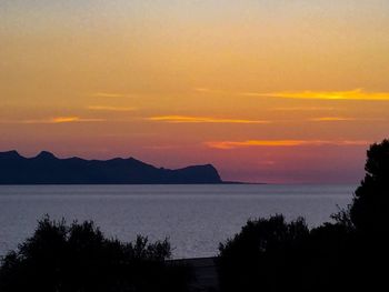 Scenic view of sea against orange sky