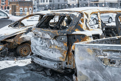 Few burnt out cars. not recoverable vehicles destroyed by fire. rusty pile of metal. insurance case.