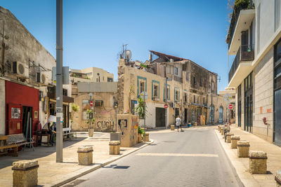 Street amidst buildings against sky in city