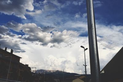 Low angle view of building against cloudy sky