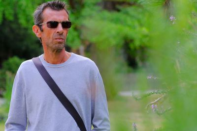 Portrait of man wearing sunglasses standing outdoors