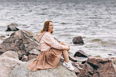 Woman on rock at beach