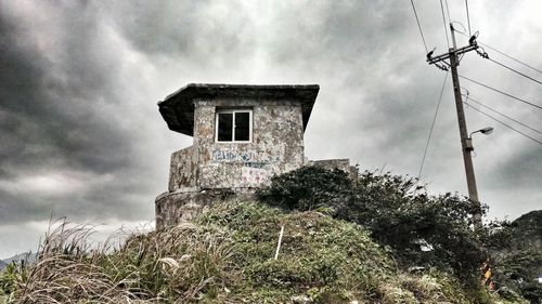 Low angle view of built structure against cloudy sky