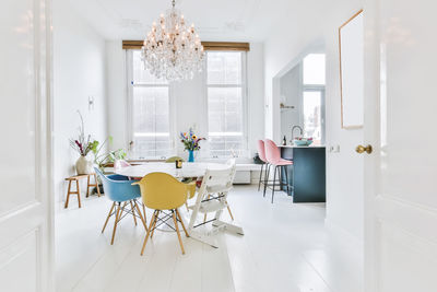 Empty chairs and table by window at home