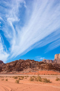 View of desert against cloudy sky