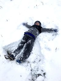 Midsection of person on snowcapped field during winter