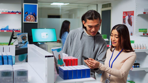 Portrait of young woman using digital tablet at office