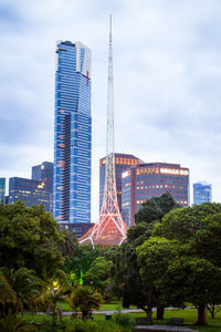 Buildings in city against cloudy sky