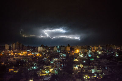 Panoramic view of illuminated city against sky at night