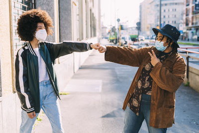 Friends standing on street in city