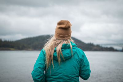 Rear view of woman standing against sky