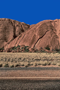 Scenic view of desert against clear blue sky