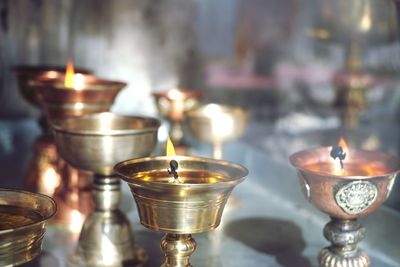 Close-up of lit tea light candles in temple