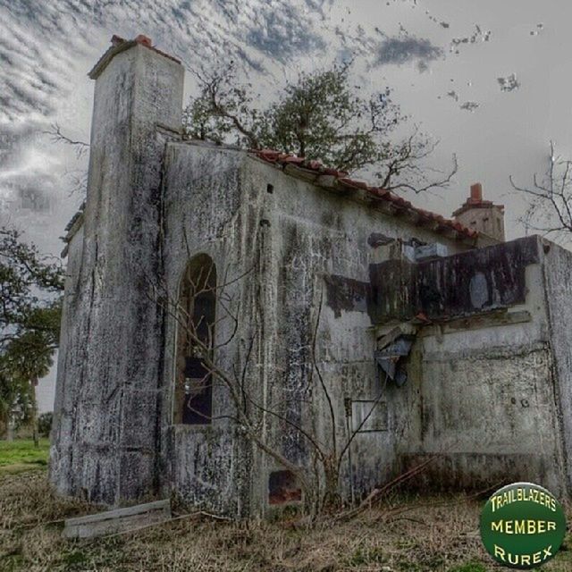 architecture, building exterior, built structure, abandoned, old, obsolete, weathered, deterioration, damaged, run-down, sky, text, tree, low angle view, western script, communication, bad condition, day, outdoors, field