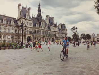 People riding bicycles on street in city