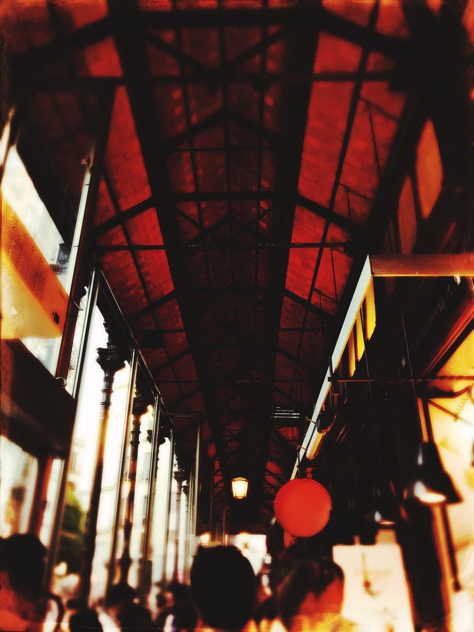 LOW ANGLE VIEW OF PEOPLE IN ILLUMINATED CORRIDOR