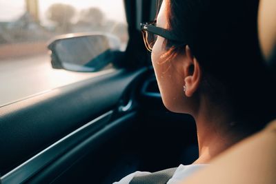 Close-up portrait of young woman in car