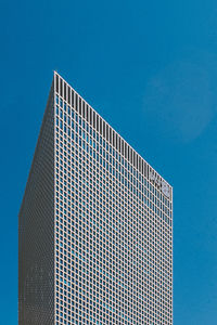 Low angle view of modern building against blue sky