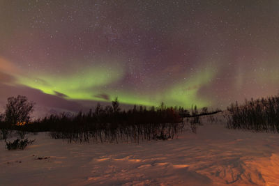 Scenic view of snowcapped mountains against sky at night