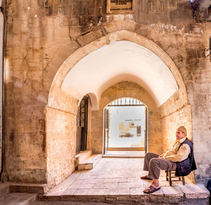 Man sitting at historic building