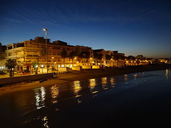 Illuminated buildings at waterfront