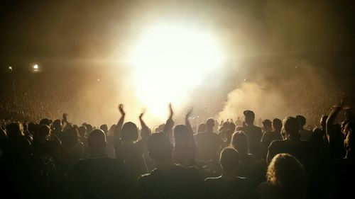 People enjoying music concert at night