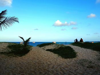 Scenic view of beach against blue sky