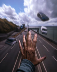 Midsection of person on road against sky