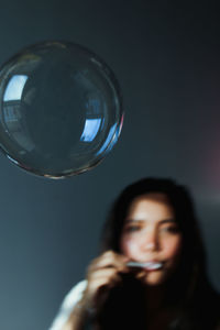 Portrait of a beautiful young woman in bubbles