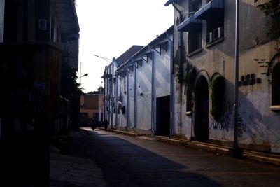 Empty street amidst buildings against sky