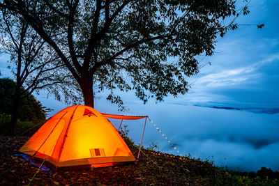 Tent on field against sky