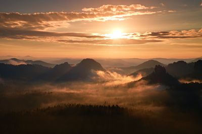 Cold morning at the end of summer. colorful summer morning with golden light and fog between hills