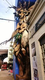 Low angle view of statue in city against sky