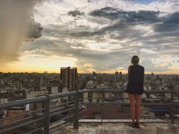 View of cityscape against cloudy sky