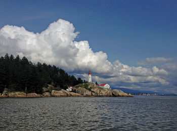 Panoramic view of sea and buildings against sky