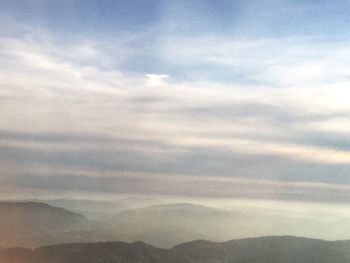 Scenic view of mountains against cloudy sky