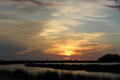 Scenic view of lake at sunset