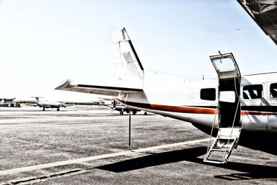 Airplane on runway against sky