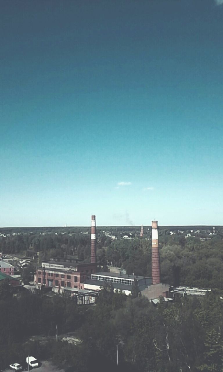 clear sky, copy space, built structure, architecture, water, sea, blue, building exterior, city, horizon over water, cityscape, connection, outdoors, bridge - man made structure, tranquility, sky, day, beach, sunlight, nature