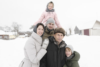 Family portrait with grandfather in winter