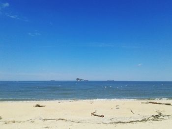 Scenic view of sea against blue sky