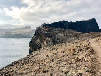 Scenic view of sea and mountains against sky