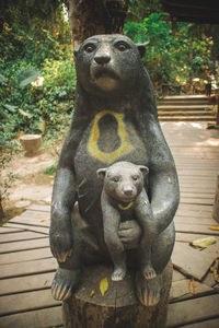 Statue against tree trunk