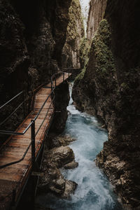 High angle view of bridge over waterfall in forest