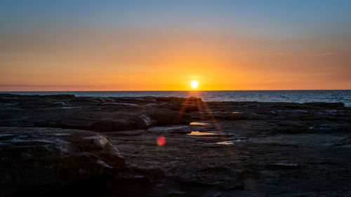 Scenic view of sea against sky during sunset